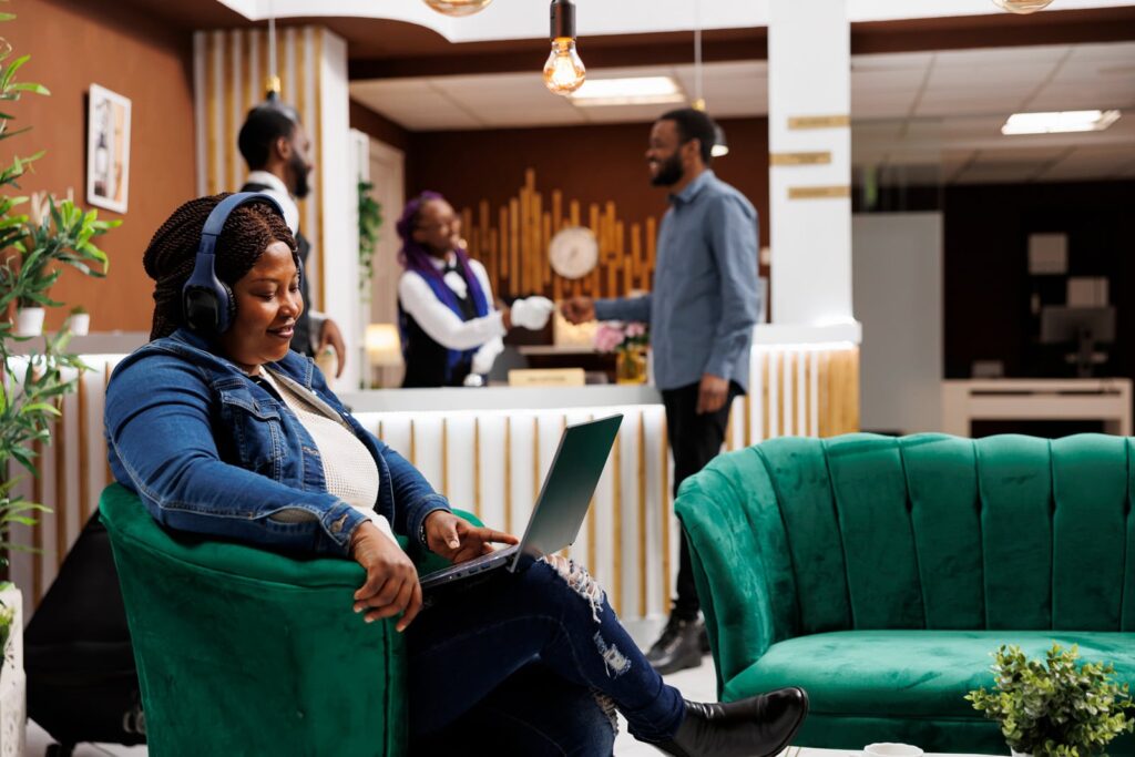 A female travel advisor working on her website in a hotel lobby