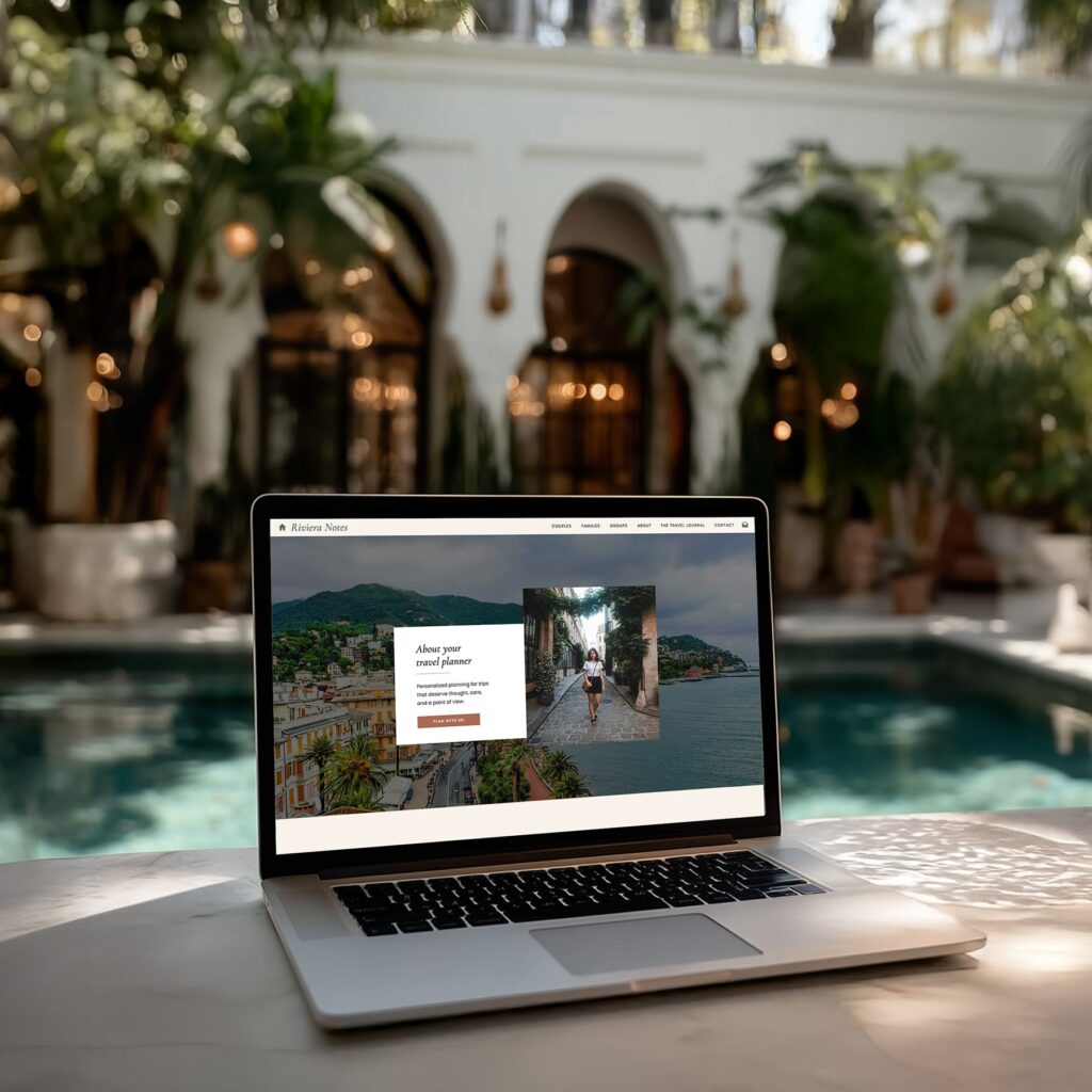 laptop beside a resort pool with a travel agency website on screen