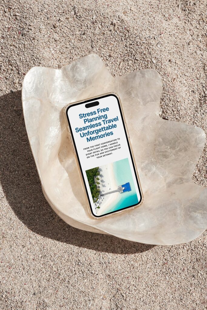 A phone on a beach shell, with a travel advisor website on screen 